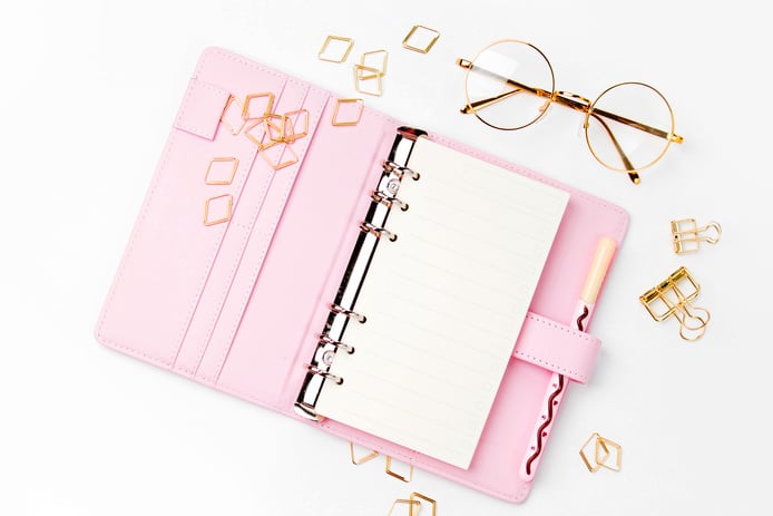 Pink planner with Business Stationery concept. Flat lay, top view